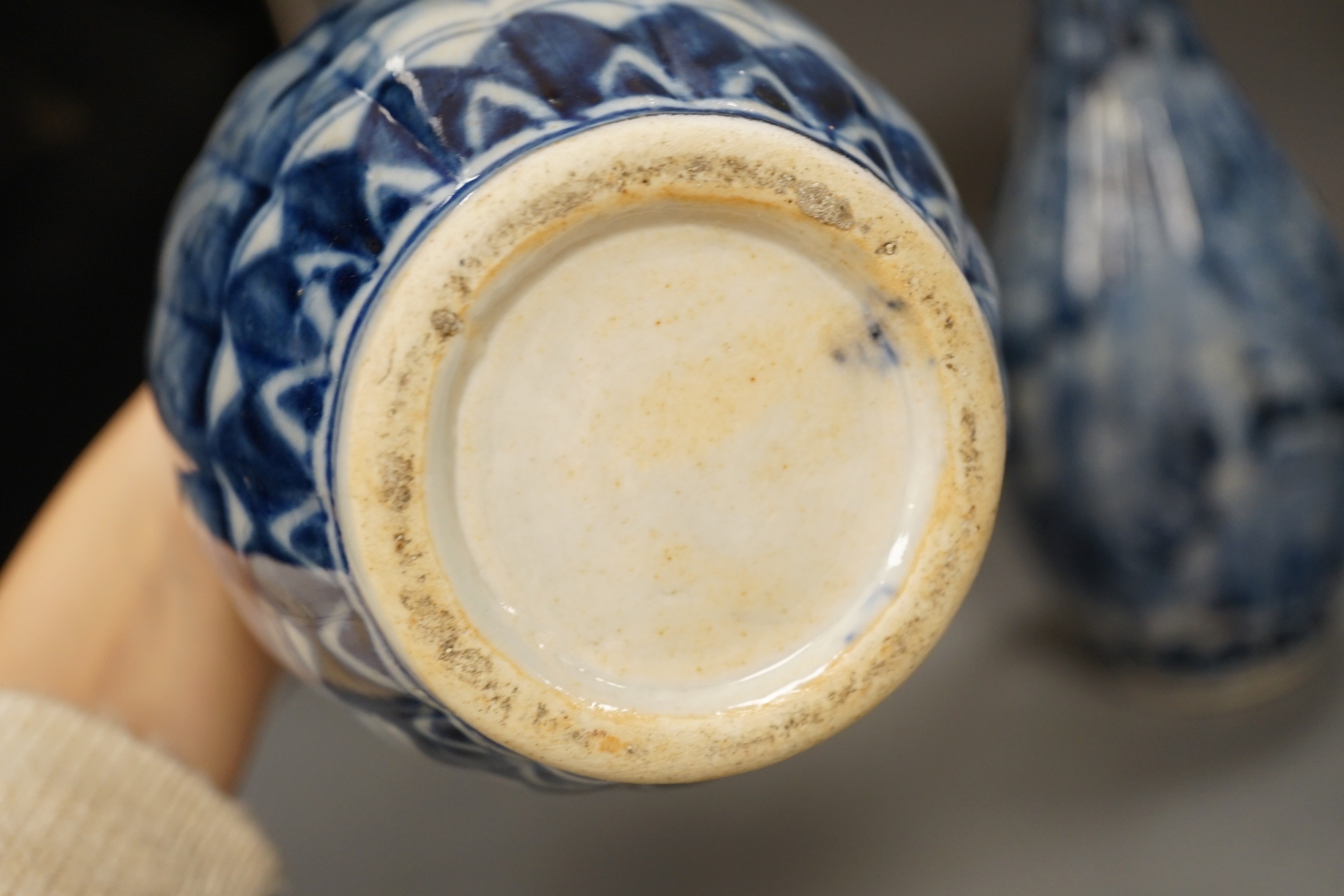 A pair of early 20th century Japanese fluted blue and white flared rim vases, 31.5cm